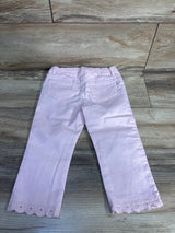 Back view of pink OshKosh toddler jeans (24M) showing scalloped embroidered hem and elastic waistband on wood background