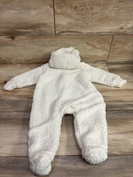 Laid-flat view of H&M Sherpa Hooded Bunting in ivory, showcasing its sherpa texture and hood on a wood floor