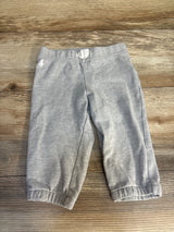 Light grey toddler pants with elastic cuffs and waistband on wooden background