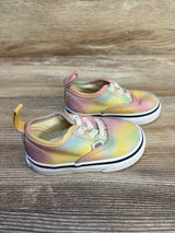 Toddler tie-dye Vans sneakers with pastel rainbow colors on wooden background