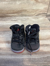 Black and red toddler Jordan sneakers on wood floor, kids footwear resale