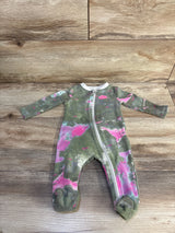 Flat lay of Nike zip-front footed sleeper green with pink accents showing diagonal zipper and Nike logo on wood background