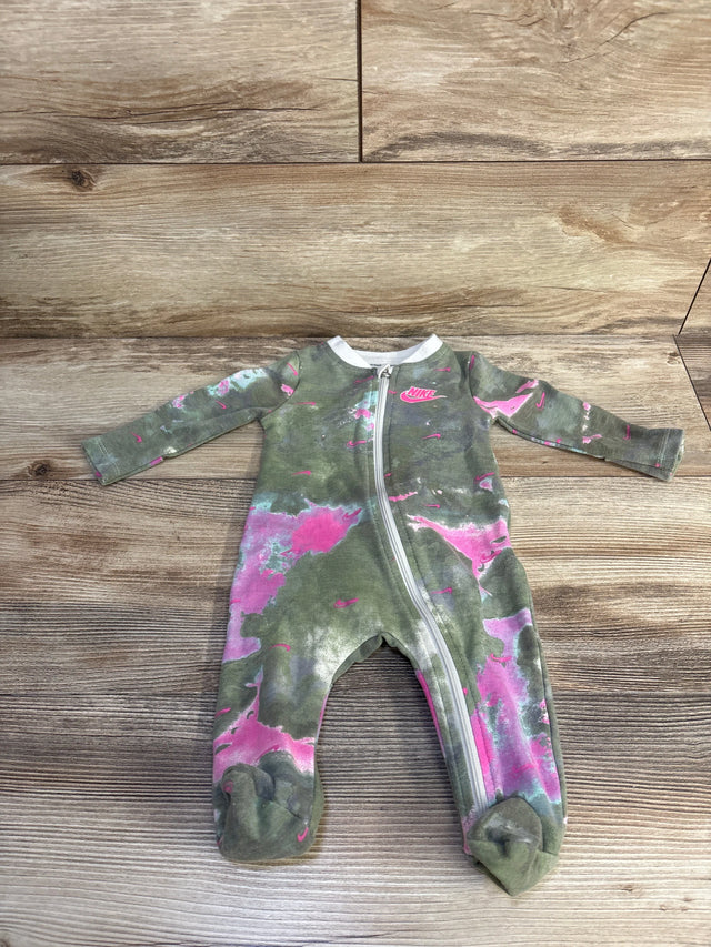 Flat lay of Nike zip-front footed sleeper green with pink accents showing diagonal zipper and Nike logo on wood background