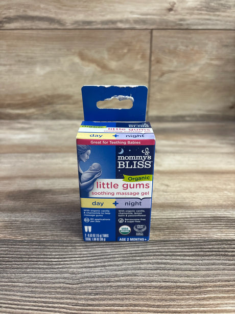 Front view of Mommy’s Bliss Organic Little Gums soothing massage gel 2-pack showing day and night formulas on a wooden surface