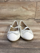 Front view of Cat & Jack Nora slip-on ballet flats, size 7C, showing bow detail and elastic strap on wood floor background