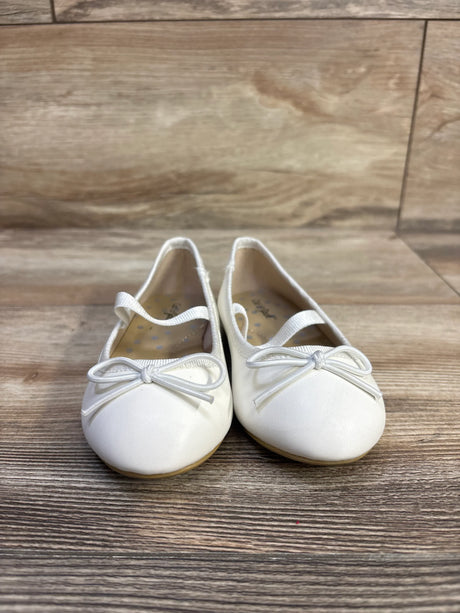 Front view of Cat & Jack Nora slip-on ballet flats, size 7C, showing bow detail and elastic strap on wood floor background