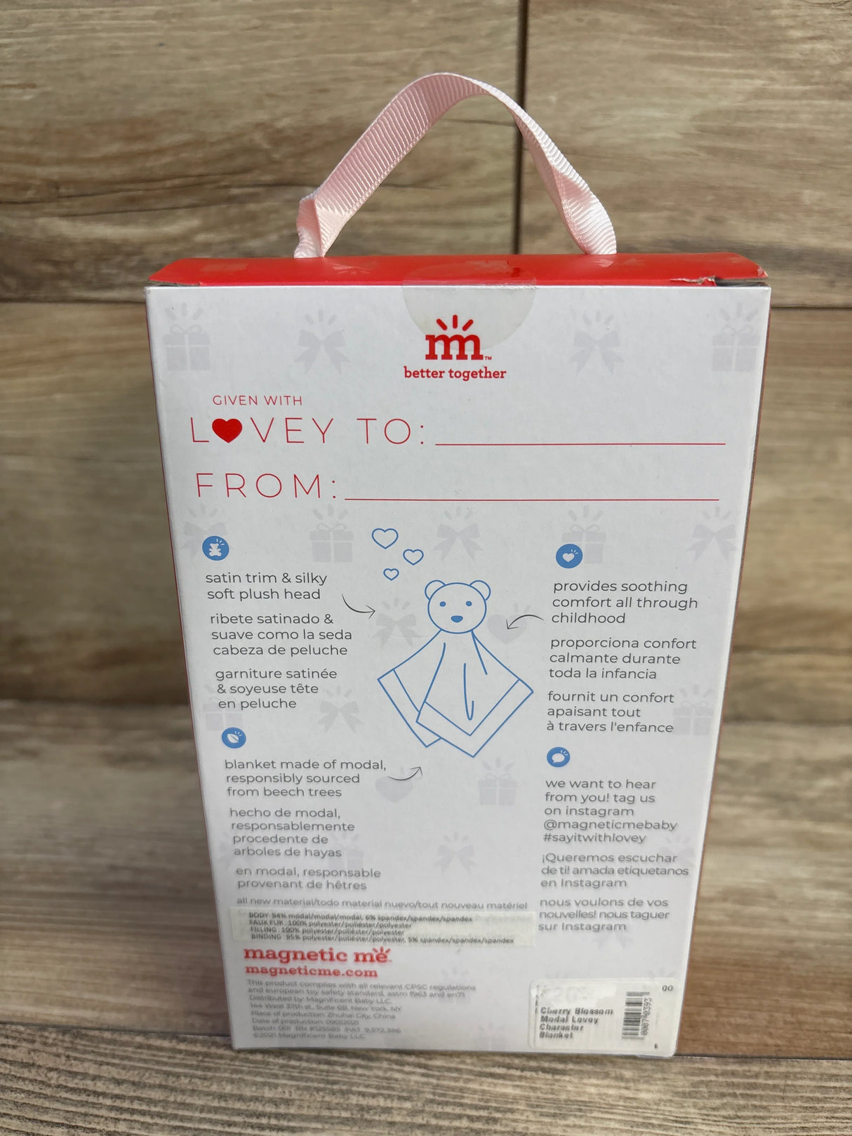 Rear view of Cherry Blossom modal lovey box showing satin ribbon handle, 'Lovey To/From' label and illustration on wood