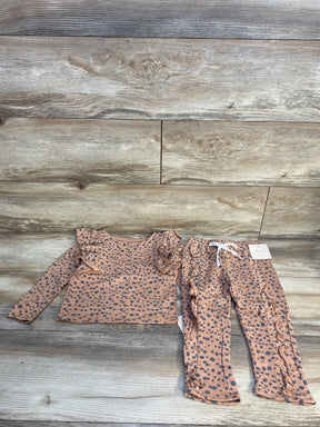 Girls' pink polka dot ruffle long sleeve top and pants set on wood background
