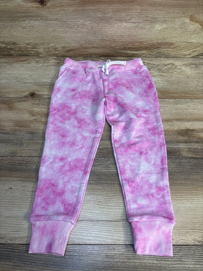 Pink and white tie-dye toddler jogger sweatpants with drawstring on wood background