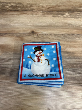 Children’s cloth book with snowman illustration on wood surface, titled A Snowman Story