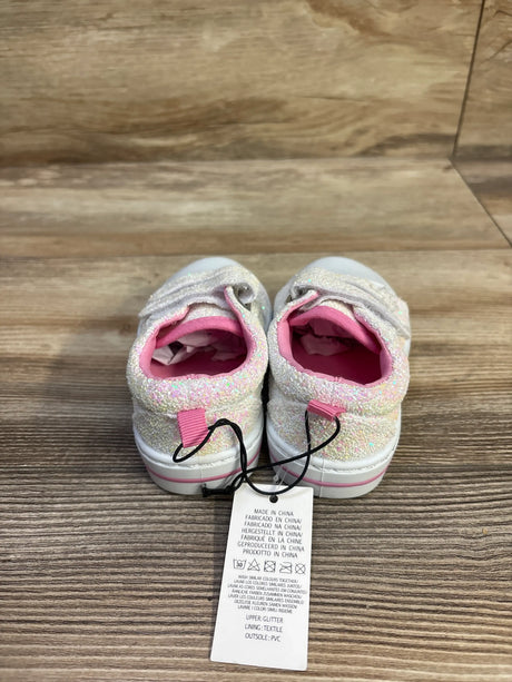Rear view of Bocca canvas walking sneakers showcasing glittery white uppers, pink lining, and two strap closures on a wood floor