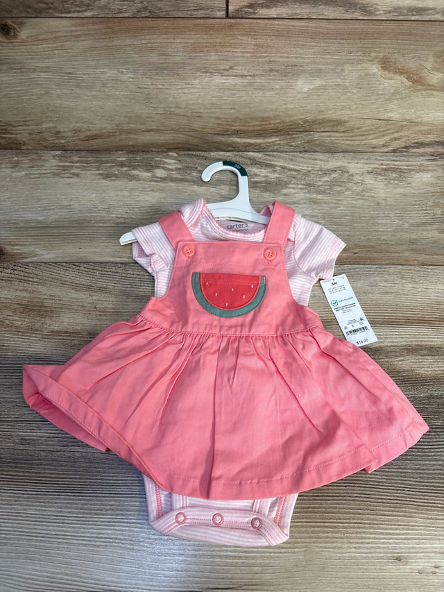 Pink baby girl romper dress with watermelon patch, short sleeves, on wooden background