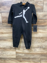 Black infant hooded jumpsuit with white basketball player silhouette, zipper front, wooden background