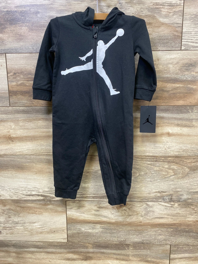 Black infant hooded jumpsuit with white basketball player silhouette, zipper front, wooden background