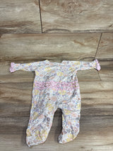 Infant floral print sleeper with pink ruffles and ruffle cuffs laid flat on wooden floor