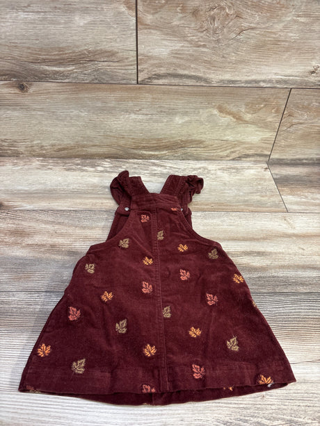 Front view of Cynthia Rowley maroon corduroy skirtall with embroidered turkey motifs on a wood-look background