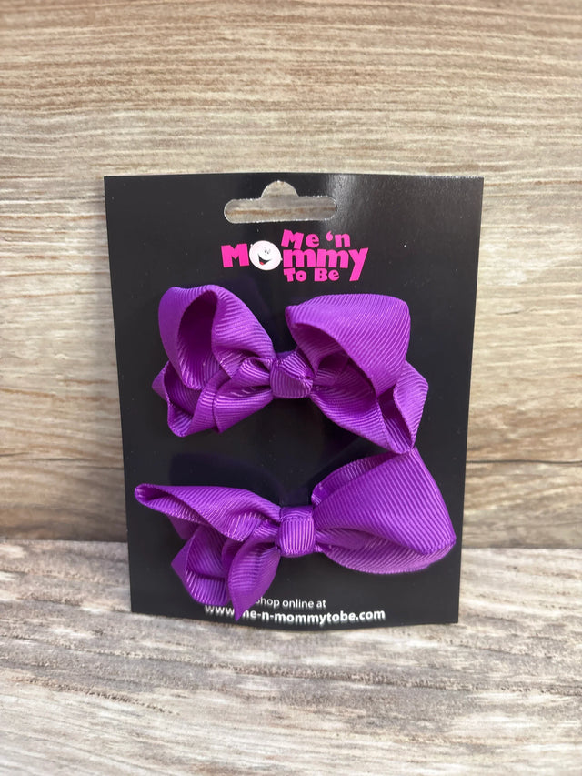 Front view of 2 purple grosgrain ribbon hair bows on black display card with Me n Mommy To Be logo and wood background