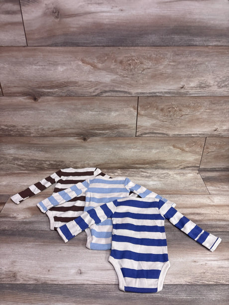Front view of Carter’s three long sleeve striped bodysuits in brown, light blue, and royal blue on a wood plank background