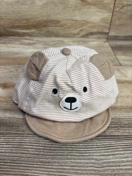 Front view of Wander and Dreams Infant Bear Hat showcasing bear face, ears, and brim against a wood grain background