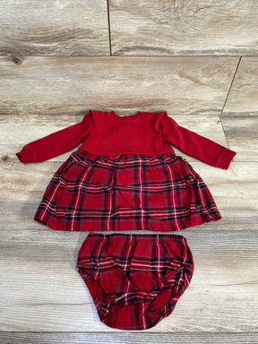 Red long-sleeve baby dress with ruffle shoulders and matching plaid diaper cover on wooden floor