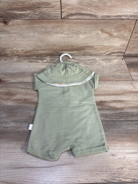 Flat lay of green Henley shortie romper and matching hat on hanger showcasing Henley buttons and cuffed legs on wood background