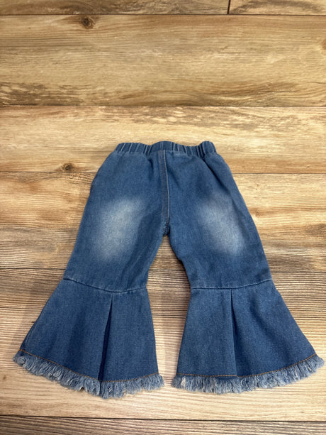 Psainyal blue bell bottom jeans for infants with frayed hems on a wooden surface