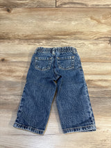 Back view of Cat and Jack paperbag pants, blue, size 18M, elastic waist, back pockets, cuffed hems on wooden floor