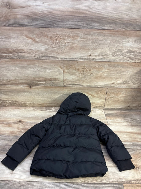 Rear view of Okie Dokie Puffer Jacket black size 3T showcasing hood and horizontal quilting on a wood floor