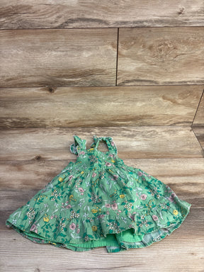 Flat lay of Cat and Jack green floral tank dress showing ruffled hem, tiered skirt and ruffled straps on wood background