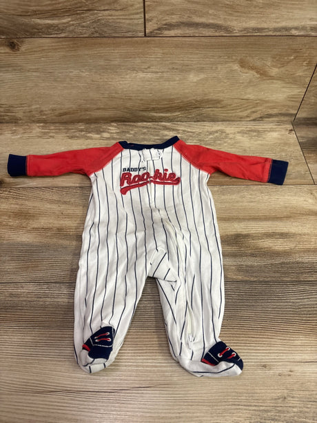 Front view of Child Of Mine Daddy’s Rookie sleeper with white pinstripes, red sleeves, and navy accents on a wood floor