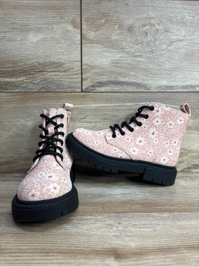 Pink floral kids boots with black laces and chunky soles on wood floor background