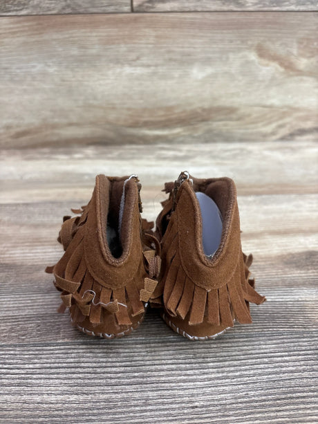 Rear view of brown Muchenggift cowboy soft sole boots in size 3C showcasing tassel fringe on a wood-look background