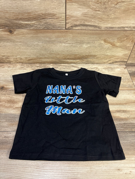 Front view of a black short-sleeve Nana’s Little Man shirt in size 5T showcasing blue and red lettering on a wood floor