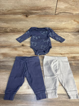 Flat lay of Cloud Island 3-piece newborn set showing navy animal-print long-sleeve bodysuit with navy and gray pants on wood floor