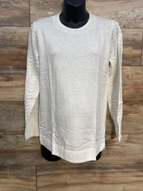 White knit sweater with lace sleeves on mannequin, wood background, women's fashion top