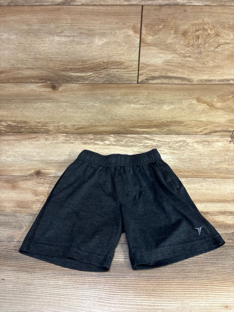 Flat lay of Old Navy kids’ grey Go-Dry athletic shorts size 5T showing elastic waistband and side pockets on wood floor background