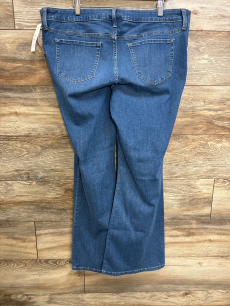 Back view of Isabel maternity flare jeans in blue, size XL, showcasing side-stretch panel and back pockets with wood floor background