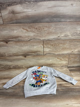 Gray Paw Patrol kids sweatshirt with cartoon dog characters on wood background