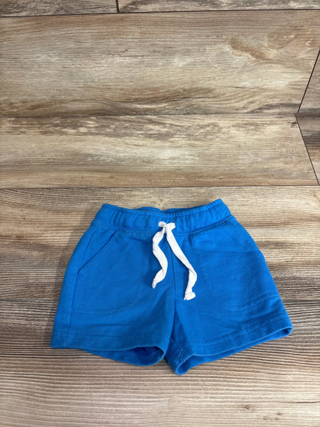 Front view of Cat & Jack toddler blue drawstring shorts showcasing elastic waistband, white drawstring and front pockets on wood background