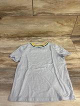 Flat lay of grey Old Navy toddler tee size 5T showing green and yellow striped neckline on wood background