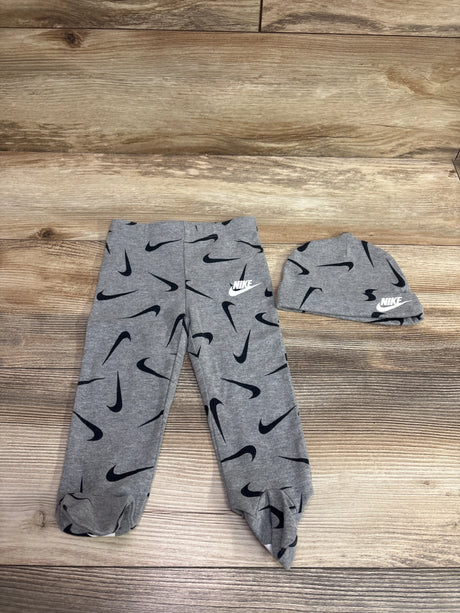 Grey Janie & Jack footed leggings and matching hat set with black swoosh pattern.