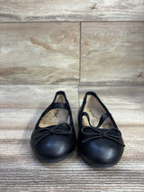 Front view of Cat & Jack Nora slip-on ballet flats size 5C showcasing elastic strap and bow detail on wood-look floor background