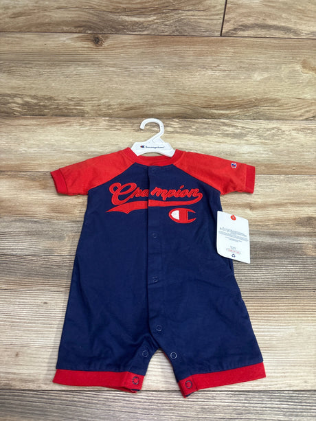 Front view of a Champion button-front shortie romper showcasing red sleeves, trim, and logo with a wood-look background