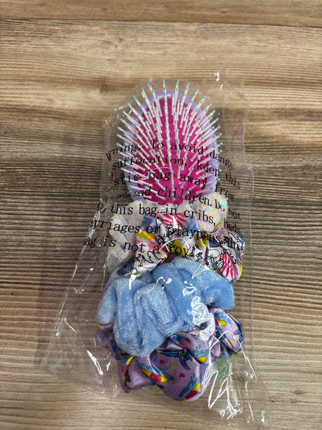 Front view of Lilo & Stitch five-piece hair set with pink and turquoise brush and colorful scrunchies in clear packaging