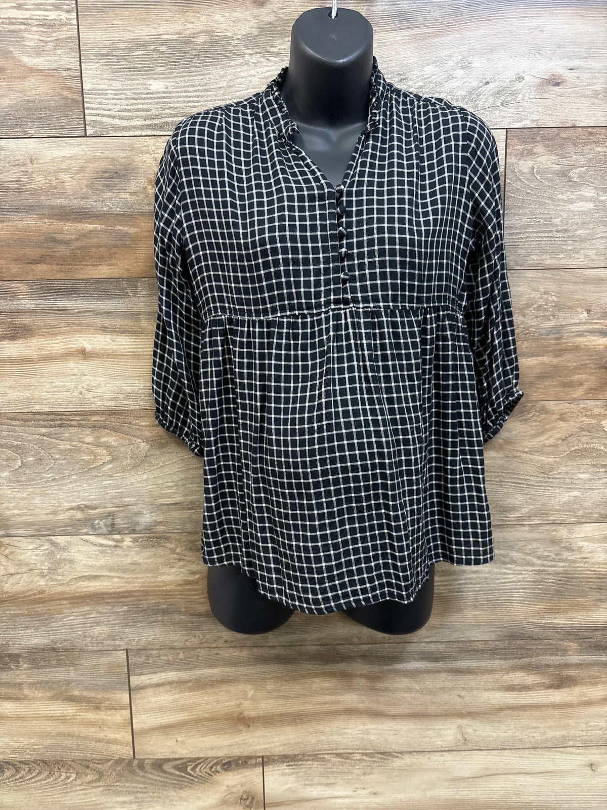 Front view of Isabel Maternity Flannel Popover Tunic showcasing black windowpane plaid, button neckline, and gathered waist on mannequin