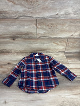 Red and navy plaid long sleeve flannel shirt for kids on wood background