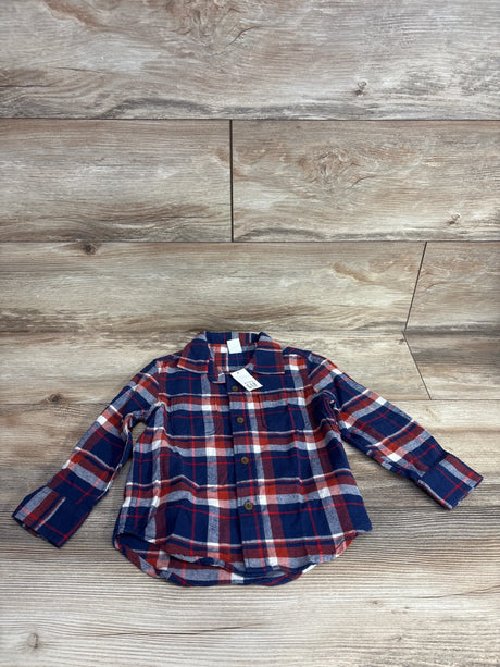 Red and navy plaid long sleeve flannel shirt for kids on wood background