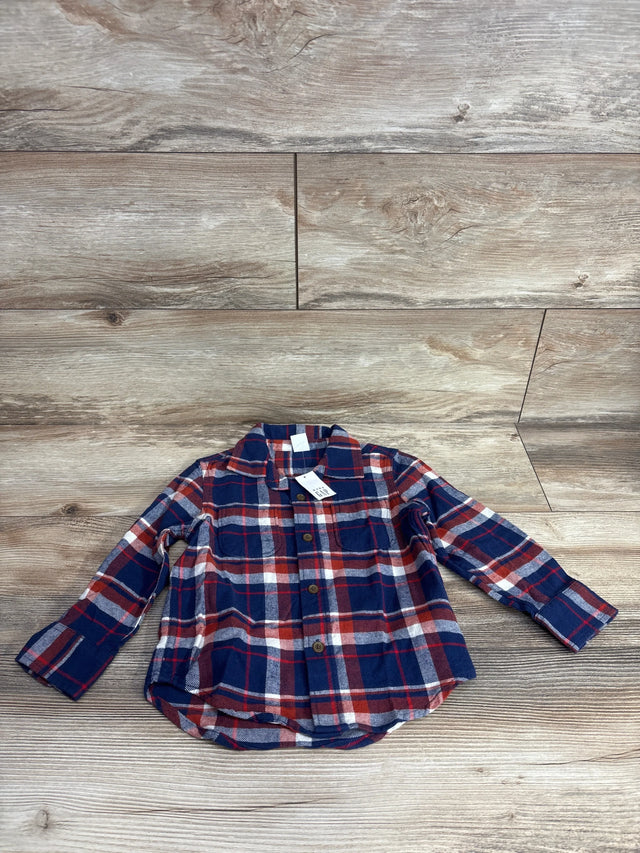 Red and navy plaid long sleeve flannel shirt for kids on wood background