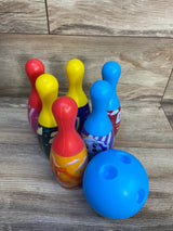 Colorful kids' plastic bowling set with blue ball and cartoon-themed pins on wood floor