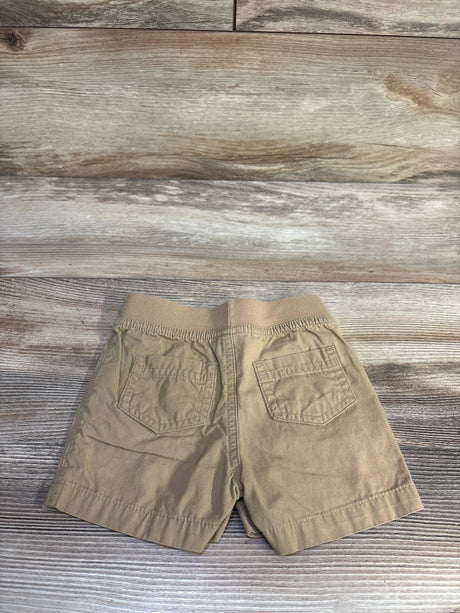 Back of tan Cat and Jack drawstring shorts with elastic waistband and two back pockets on wood background, size 3-6M